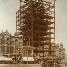 Image 1: Union Bank Tower in early construction phases with people walking in front on the sidewalks.