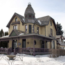 Image 1: Stodder House with snow on the rooftop and ground.