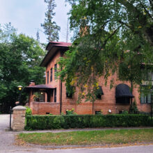 Image 2: Side view of Taylor House with a tree and a hedge alongside