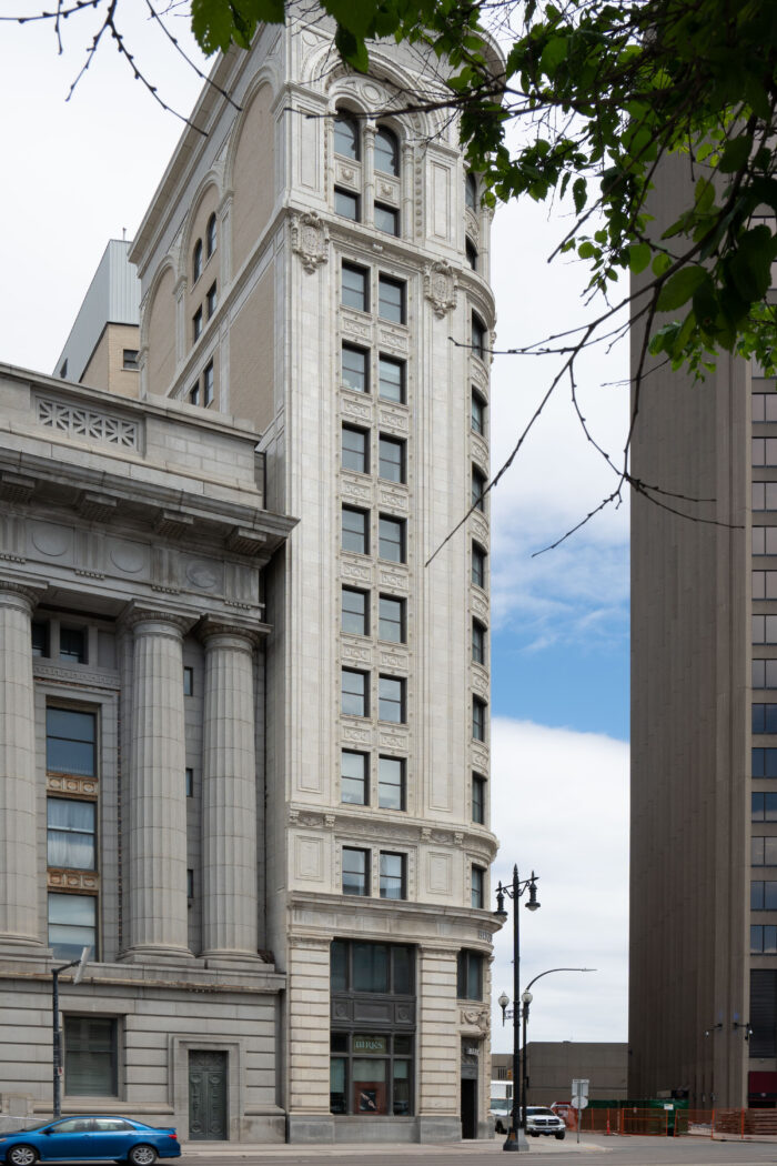 The Union Trust Building with a tree in the foreground partially obstructing the facade.