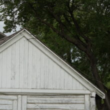 Image 7: Details of the wooden white slatted exterior on a portion of the building