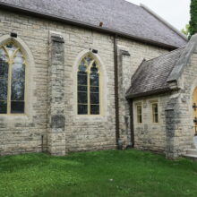 Image 14: Gothic style arched windows on the facade of St. John's Cathedral with portion of the roofing in view