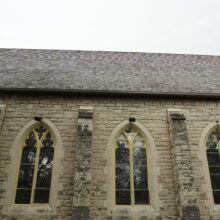 Image 13: Looking up to the roof of the church featuring gothic style arched windows on the facade of St. John's Cathedral