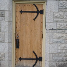 Image 10: Details of one of the wooden side doors that lead into the church with iron detailing