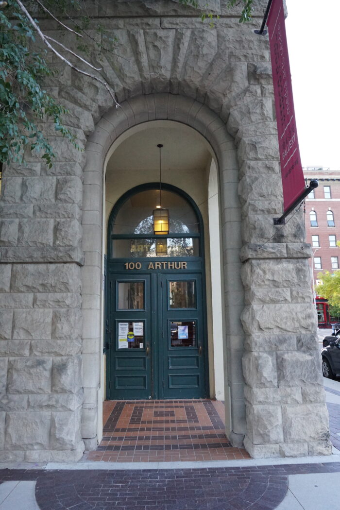 The green front doors of the Gault Building (Artspace) with the address “100 ARTHUR” posted above.