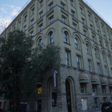 Image 3: The Gault Building (Artspace) with vehicles parked along both sides.