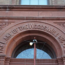 Image 4: Text on the arched portion above the front door with writing that reads "Lake of the Woods Milling Co Ltd"