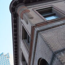 Image 6: Looking up at the corner of the building featuring the detail on the cornices