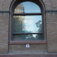 Image 8: Glass paned large arched window on the McDermot side facade of the building