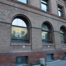 Image 9: Glass paned large arched windows facing the parking lot off of Main Street