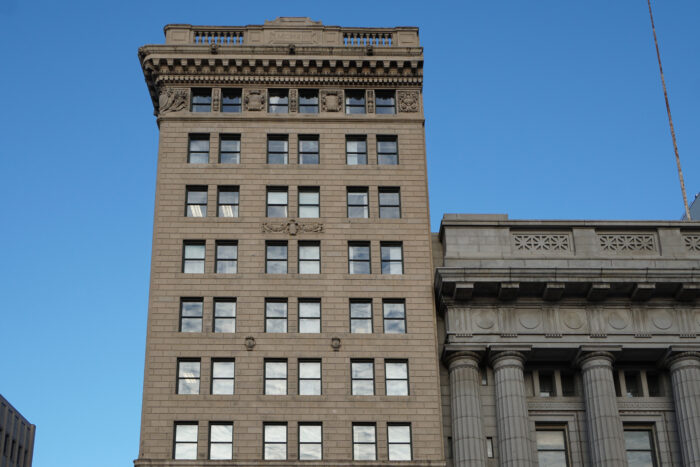 The top half of Winnipeg’s Bank of Hamilton with the number “MCMXVI” carved in the parapet.