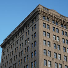 Image 1: Looking up at top floors of the Hamilton Building and cornice moulding