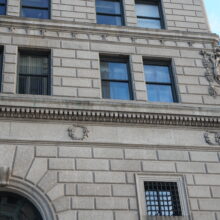 Image 2: Two medallions on band above first floor of facade