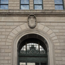 Image 3: The front entrance of Winnipeg’s Bank of Hamilton with medallion above door