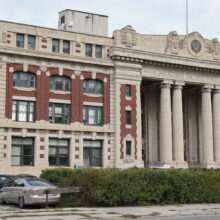 Image 1: The front entrance of Winnipeg’s Canadian Pacific Railway Station with a hedge in front