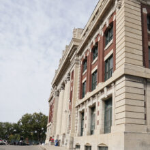 Image 6: The front facade of the CPR Station with trees in the background