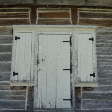 Image 1: Antique white door leading into Ross House