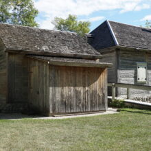 Image 3: An older wooden structure lying to the left of Ross House