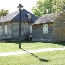 Image 5: A view of Ross House and a detached shed with a light post in front