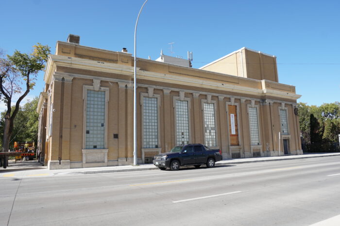 The side of the Ukrainian Labour Temple with a boarded up window. A truck is parked in front.