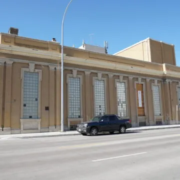 The side of the Ukrainian Labour Temple with a boarded up window. A truck is parked in front.