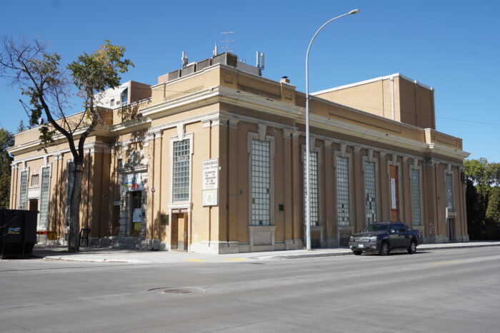 The Ukrainian Labour Temple with a tree in front and a truck parked on the street beside.