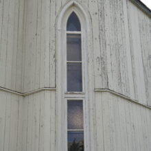 Image 5: Narrow gothic style arched windows against the facade of the building