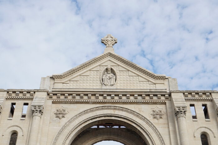 The ornamentation above the front facade of the St. Boniface Cathedral with a cross at the top.