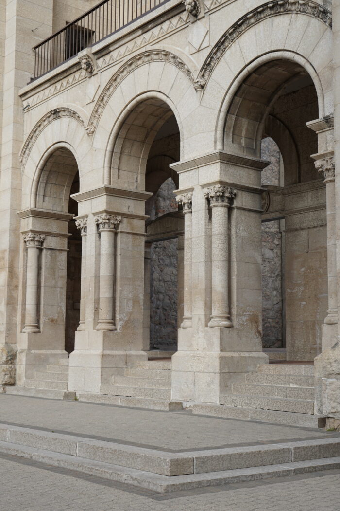 The three arches at the front entrance of the St. Boniface Cathedral with a railing above.