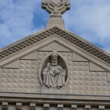 Image 17: Religious decorative details on the pediment of the original facade of the St Boniface Cathedral with stone cross on top