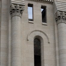 Image 20: Portion of the facade of the St Boniface Cathedral featuring decorative columns and empty arched windows