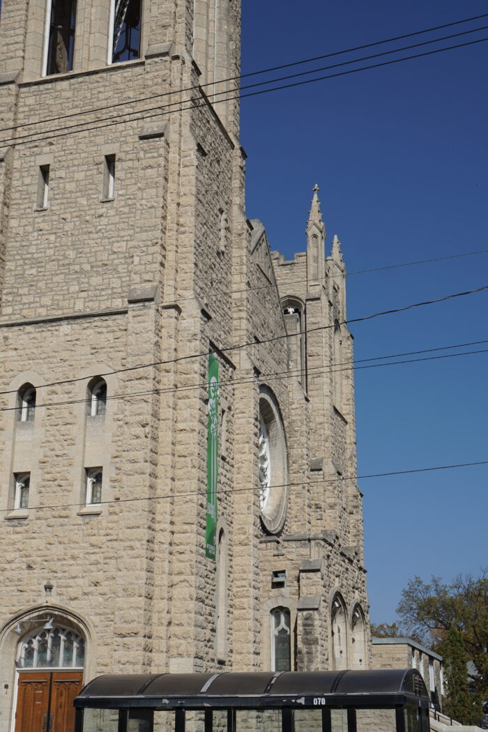 Looking across the front facade of Winnipeg’s Westminster Church with power lines in the foreground.