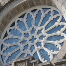 Image 8: Rose window detail on the facade of the building