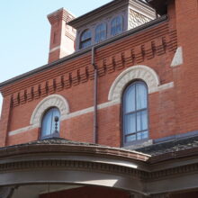 Image 1: Two second-floor arched windows above verandah