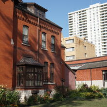 Image 14: Looking along the front facade of Dalnavert. Apartment buildings are visible in the background.