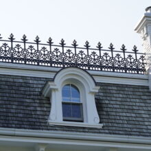 Image 9: Small dormer window and parapets on the grey roof with white trimmings on Government House