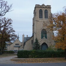 Image 1: Facade of the tower of St. Luke's Church viewed from street level from the Nassau St side