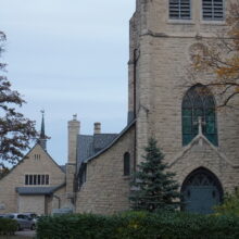 Image 2: Facade of the tower of St. Luke's Church viewed from street level from the Nassau St side