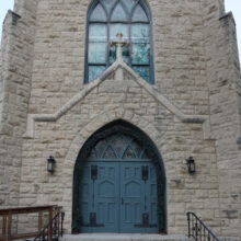 Image 3: Steps leading up to the big wooden front door of St Luke's Church