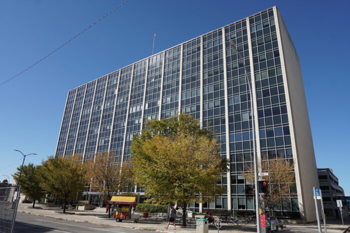 The facade of the Norquay Building with a tree in front