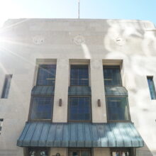 Image 1: Three long windows above entrance awning