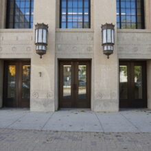 Image 3: Two gaslight-style lamps above entrance