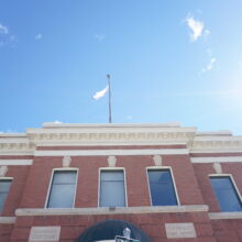 Image 1: Looking up at two windows on the second floor of the Selkirk Post Office.