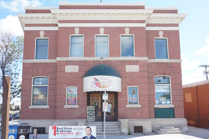 Selkirk Post Office building behind a no parking sign. Sign above the doors reads “Gwen Fox Gallery.”