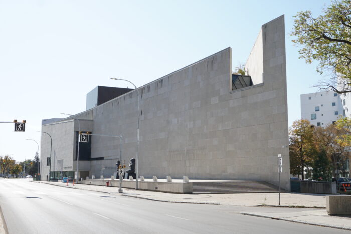 The Winnipeg Art Gallery as seen from across the street with a crosswalk in front of it.