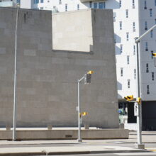 Image 2: Facade of the Winnipeg Art Gallery-Qaumajuq facing Memorial Boulevard with residential building in view