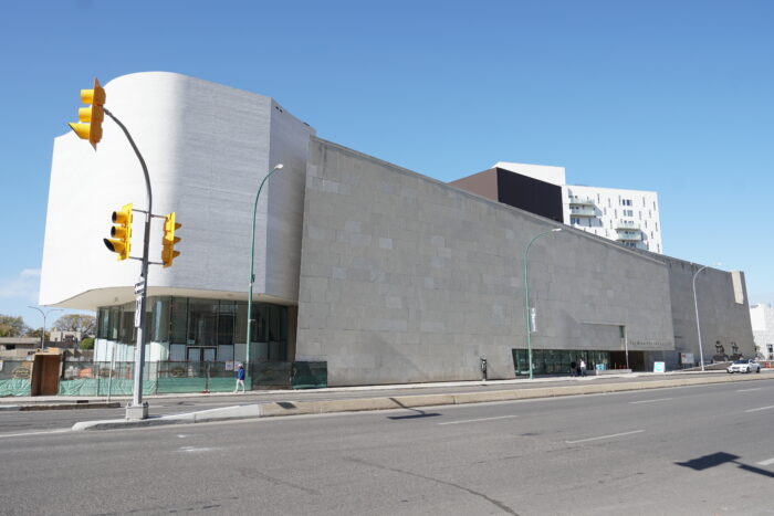 The Winnipeg Art Gallery as seen from across the street with a stoplight in front of it.