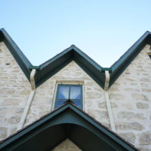 Image 1: Looking up at single window and dormer above entrance.