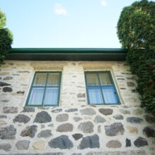 Image 5: Looking up at two windows on the second floor.