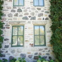 Image 6: Looking up at four windows on the side exterior wall.